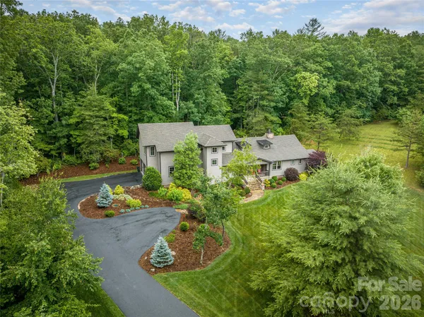 an aerial view of a house with a yard basket ball court and outdoor seating
