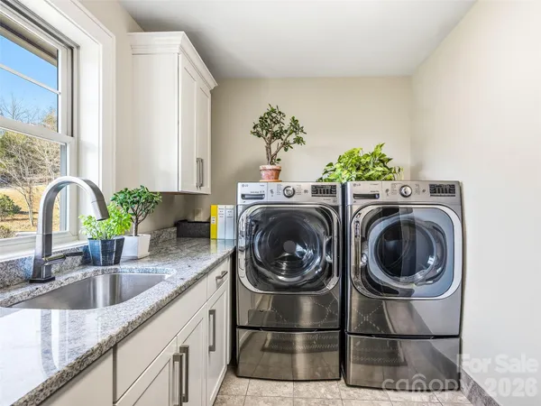 a utility room with sink washer and dryer