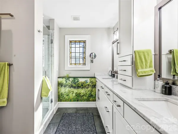 a spacious bathroom with a granite countertop sink and a large mirror