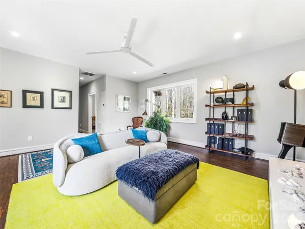 a living room with furniture rug and window