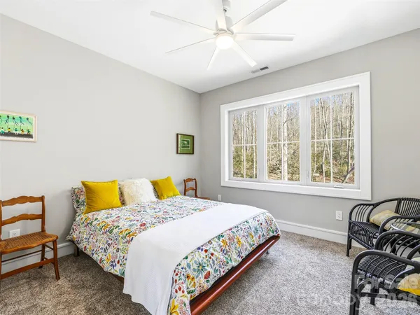a bedroom with a bed chair and window