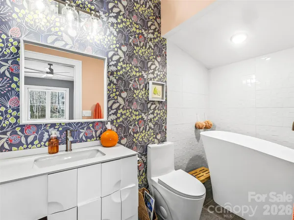 a bathroom with a sink toilet and mirror