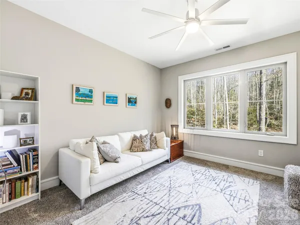 a living room with furniture and a book shelf