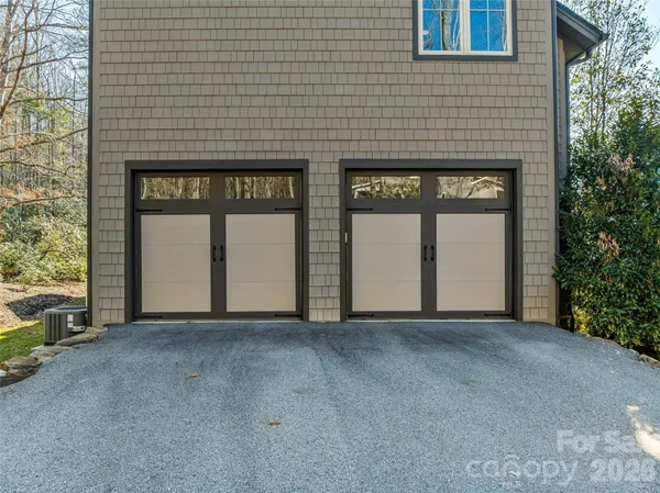 a view of a house with a small yard and wooden floor and fence