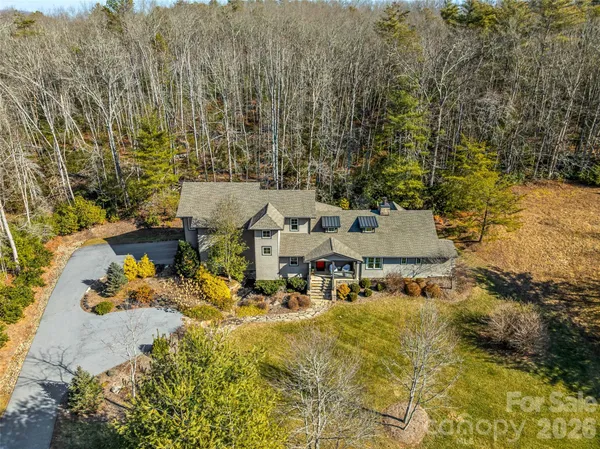 an aerial view of residential houses with yard