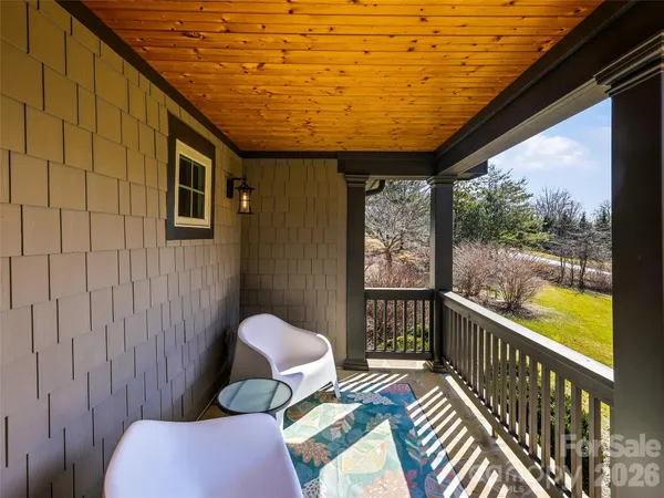 a balcony with wooden floor and furniture