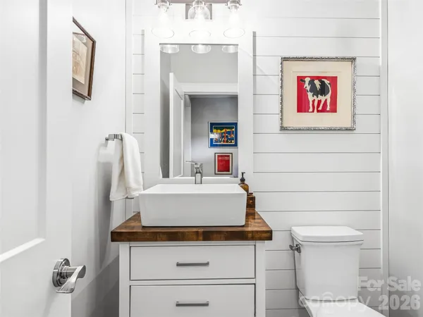 a bathroom with a toilet a sink and a mirror