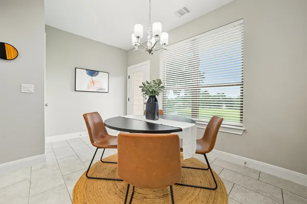 a dining room with furniture and window