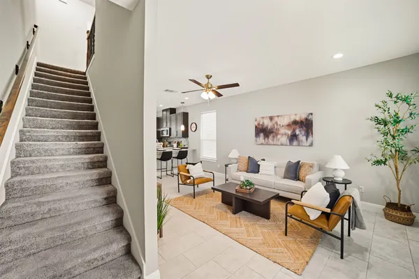 a kitchen with stainless steel appliances granite countertop sink a dining table and chairs