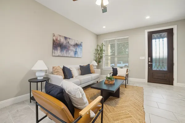 a living room with furniture and wooden floor