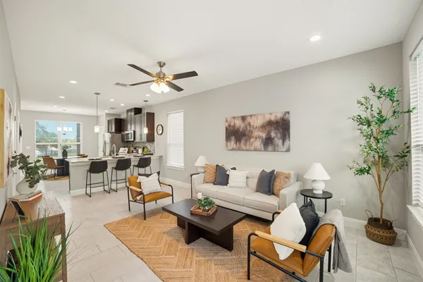 a living room with furniture a table and a potted plant