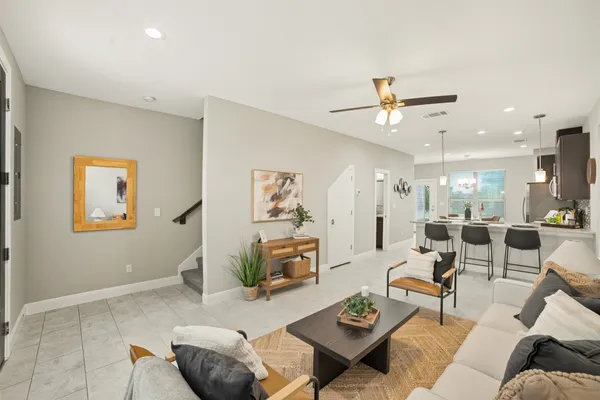 a living room with furniture and a chandelier