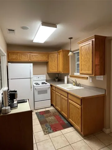 a kitchen with a sink stove and refrigerator