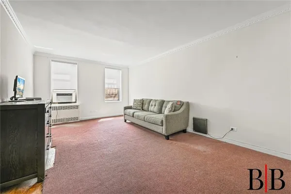 a living room with furniture and windows