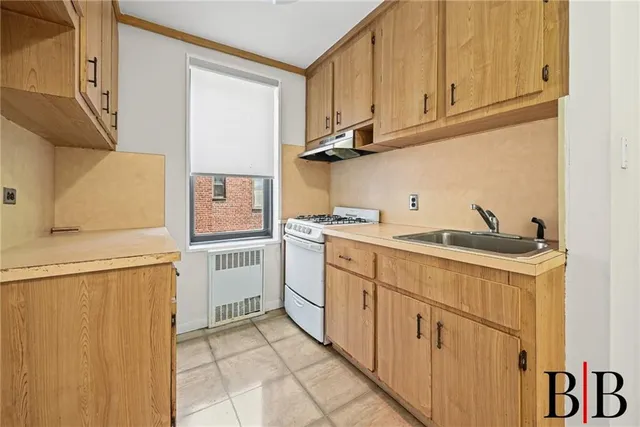 a kitchen with stainless steel appliances granite countertop a sink and a refrigerator