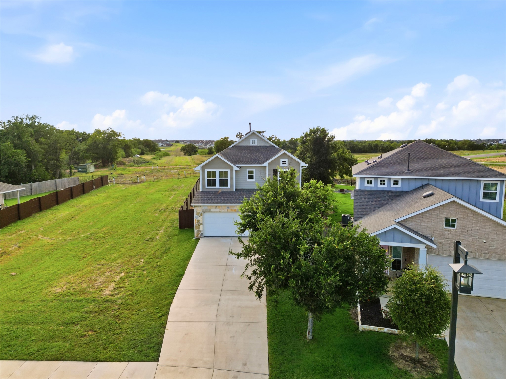 60 Bent Trl Lane Georgetown, TX 78628 - Photo 3 of 40 Elevated view reveals a charming residence with a broad driveway and ample green space.