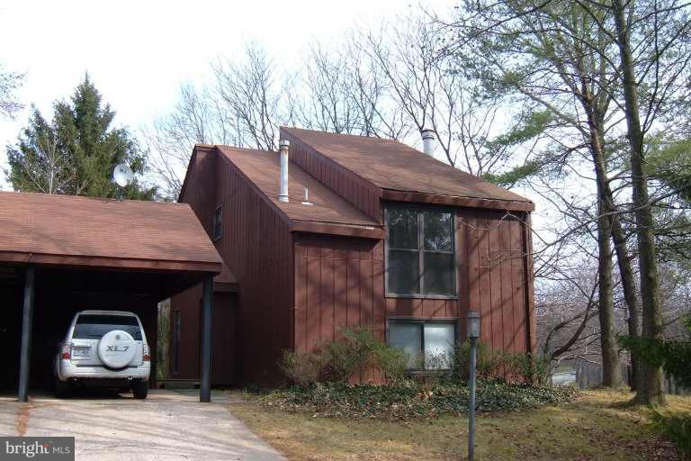8960 Blue Pool Columbia, MD 21045 - Photo 1 of 1 a house with trees in front of it