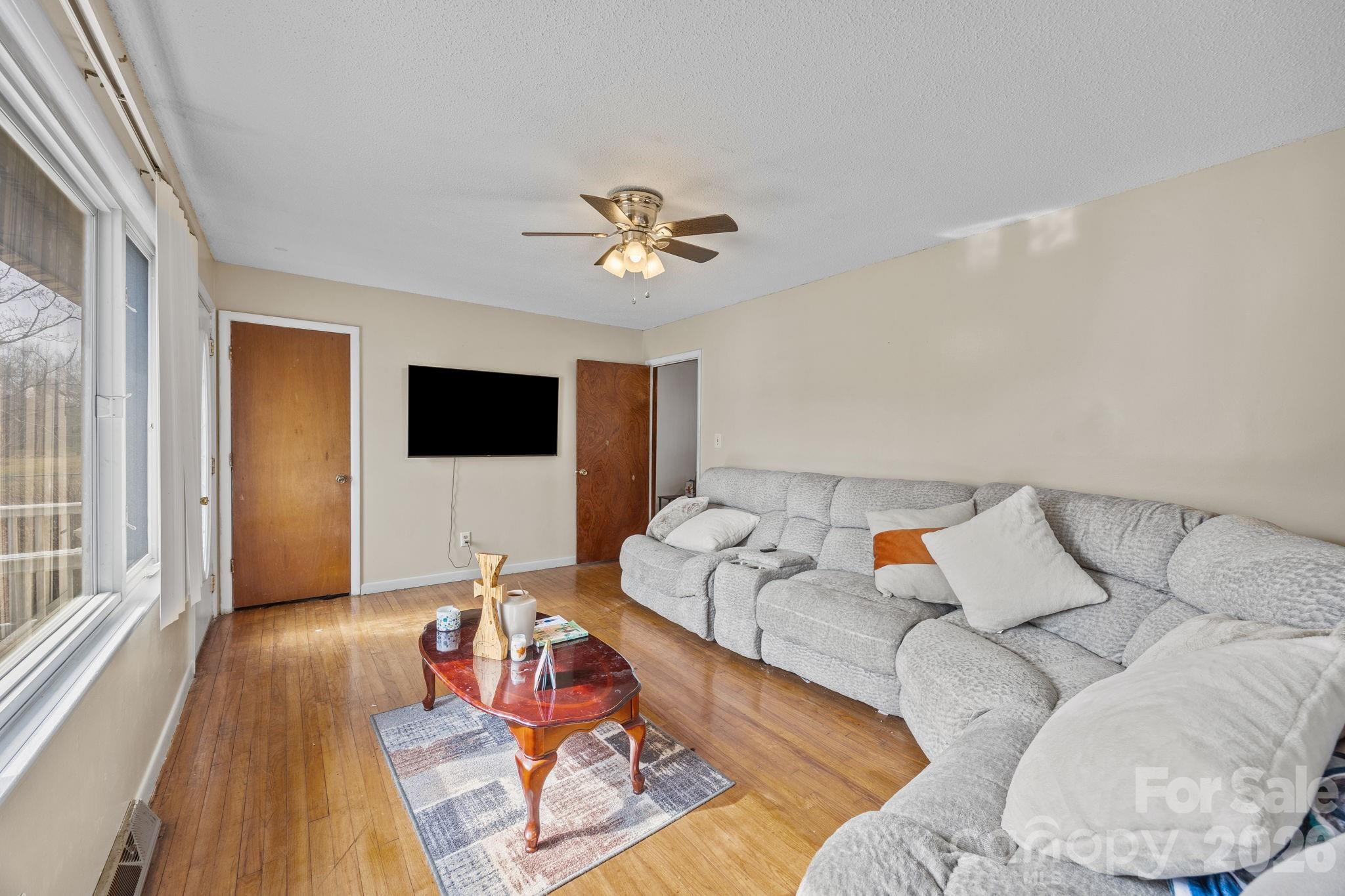 289 Washington Park Road Mount Gilead, NC 27306 - Photo 24 of 39 a living room with furniture fireplace and a flat screen tv