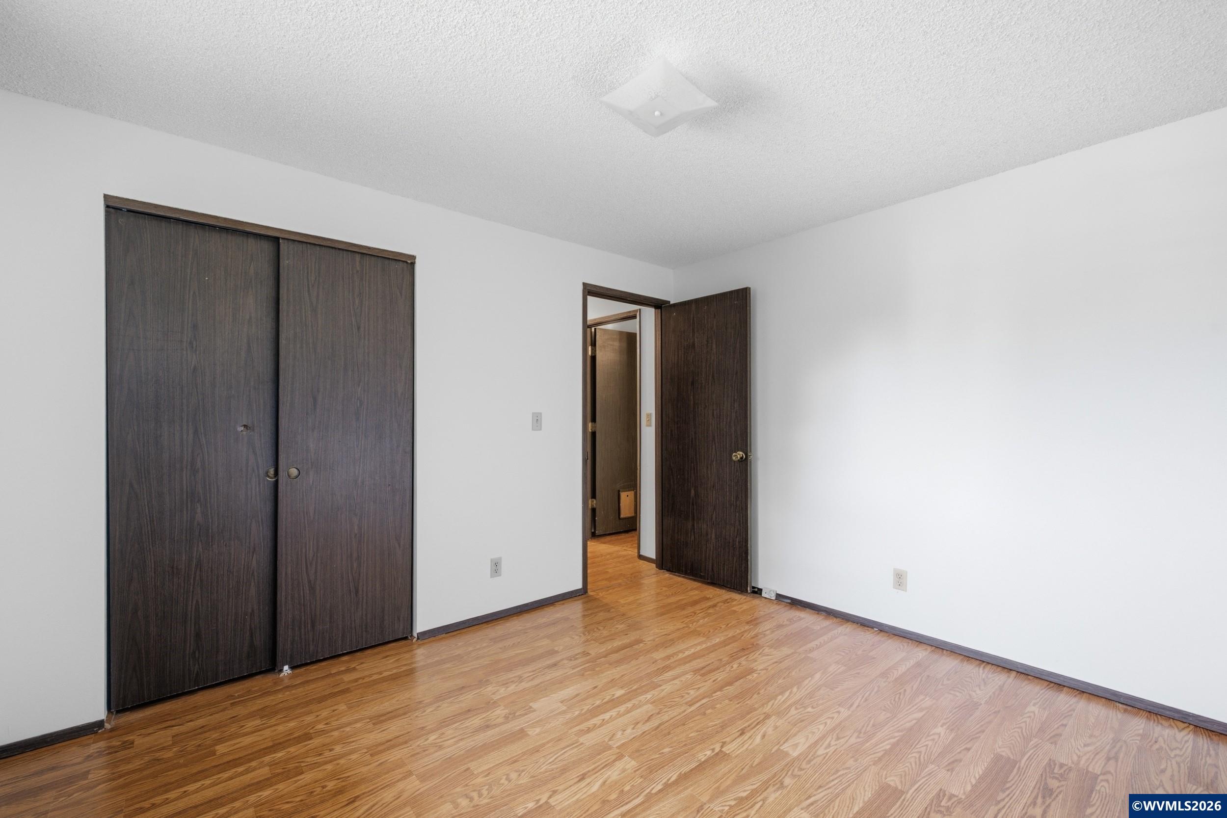 1213 Hemlock Loop Independence, OR 97351 - Photo 21 of 28 a view of an empty room with wooden floor