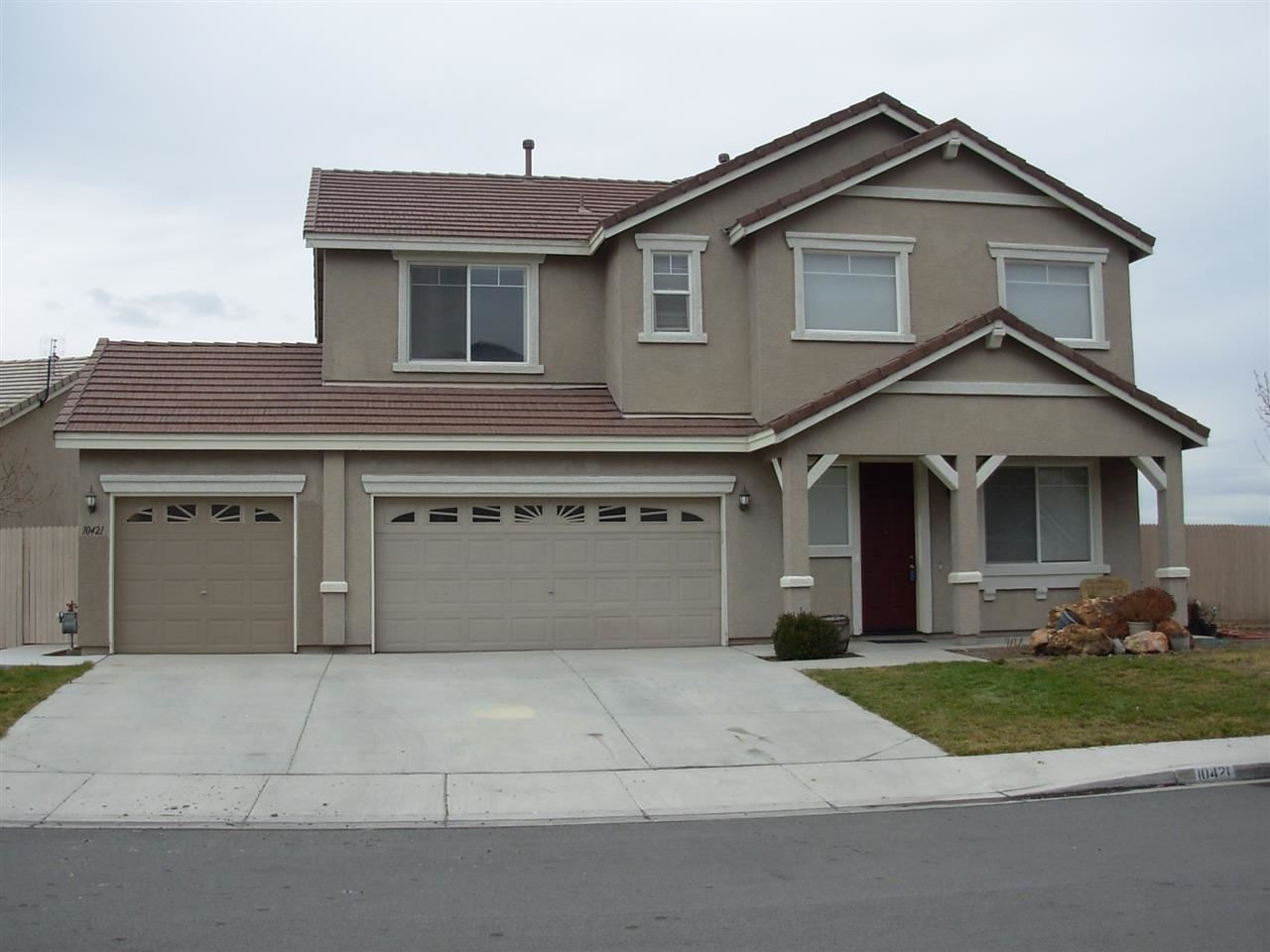10421 Blockade Drive Reno, NV 89521 - Photo 1 of 1 a front view of a house with garage and yard