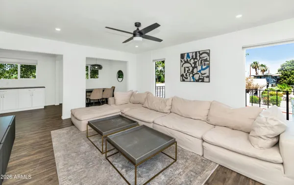 a living room with furniture and a wooden floor