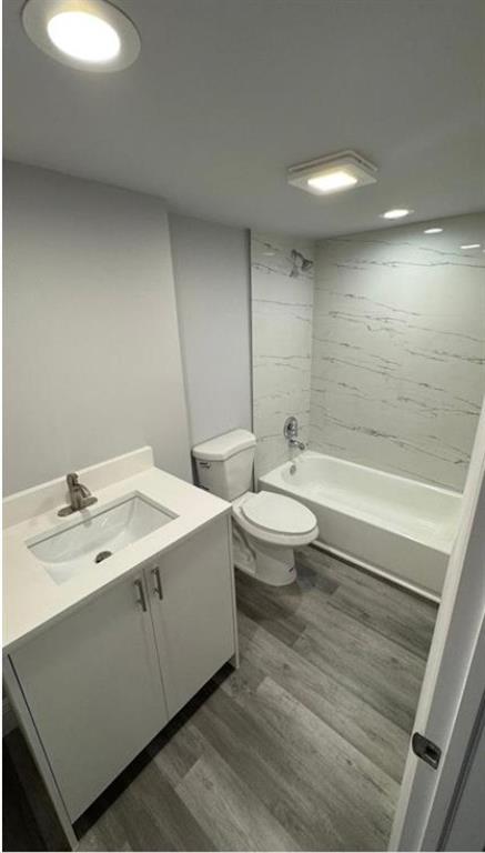 a bathroom with a double vanity sink toilet and a bathtub