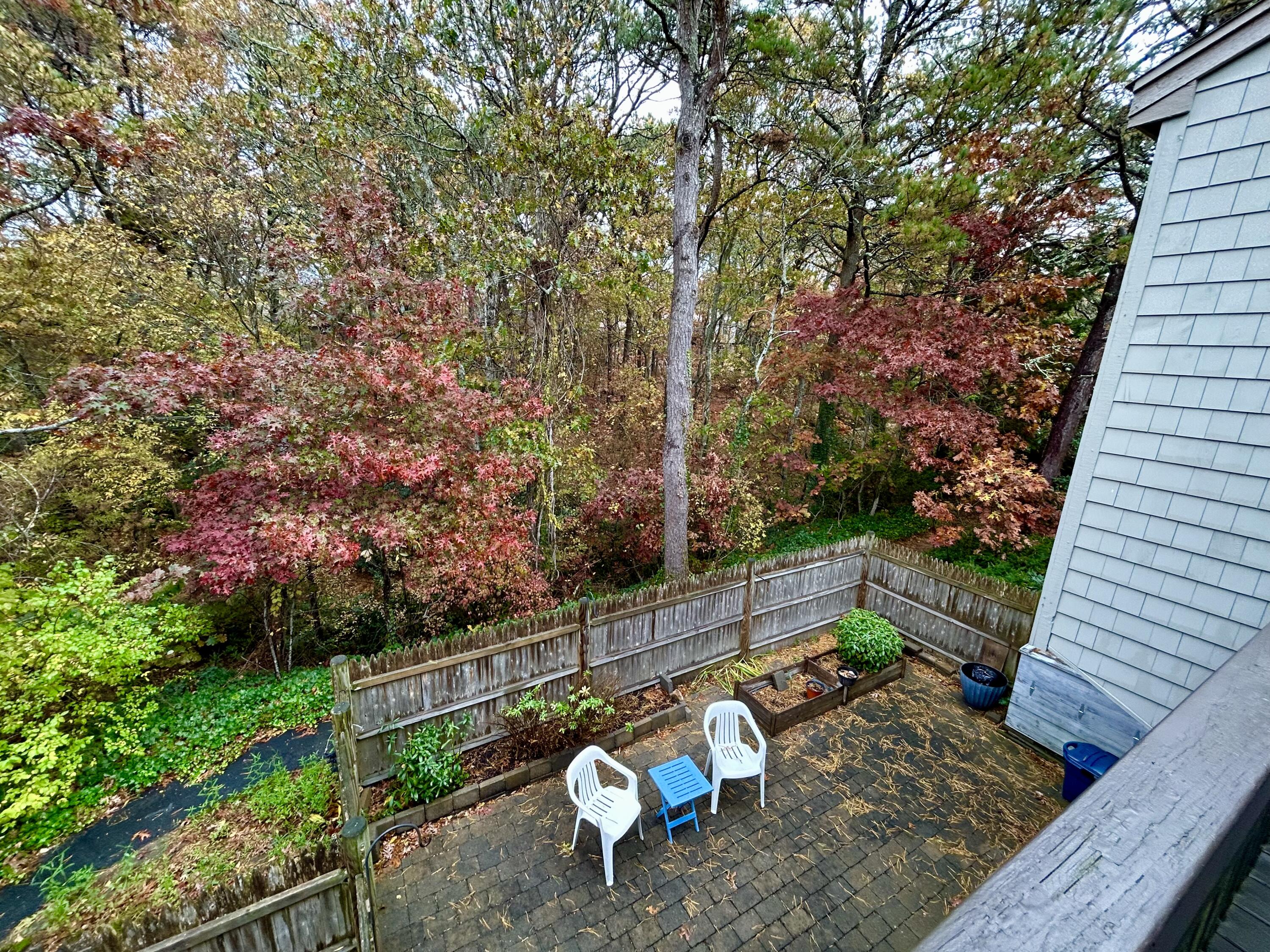 59 Main Street, Unit 192 Dennis, MA 02638 - Photo 20 of 44 a backyard of a house with table and chairs