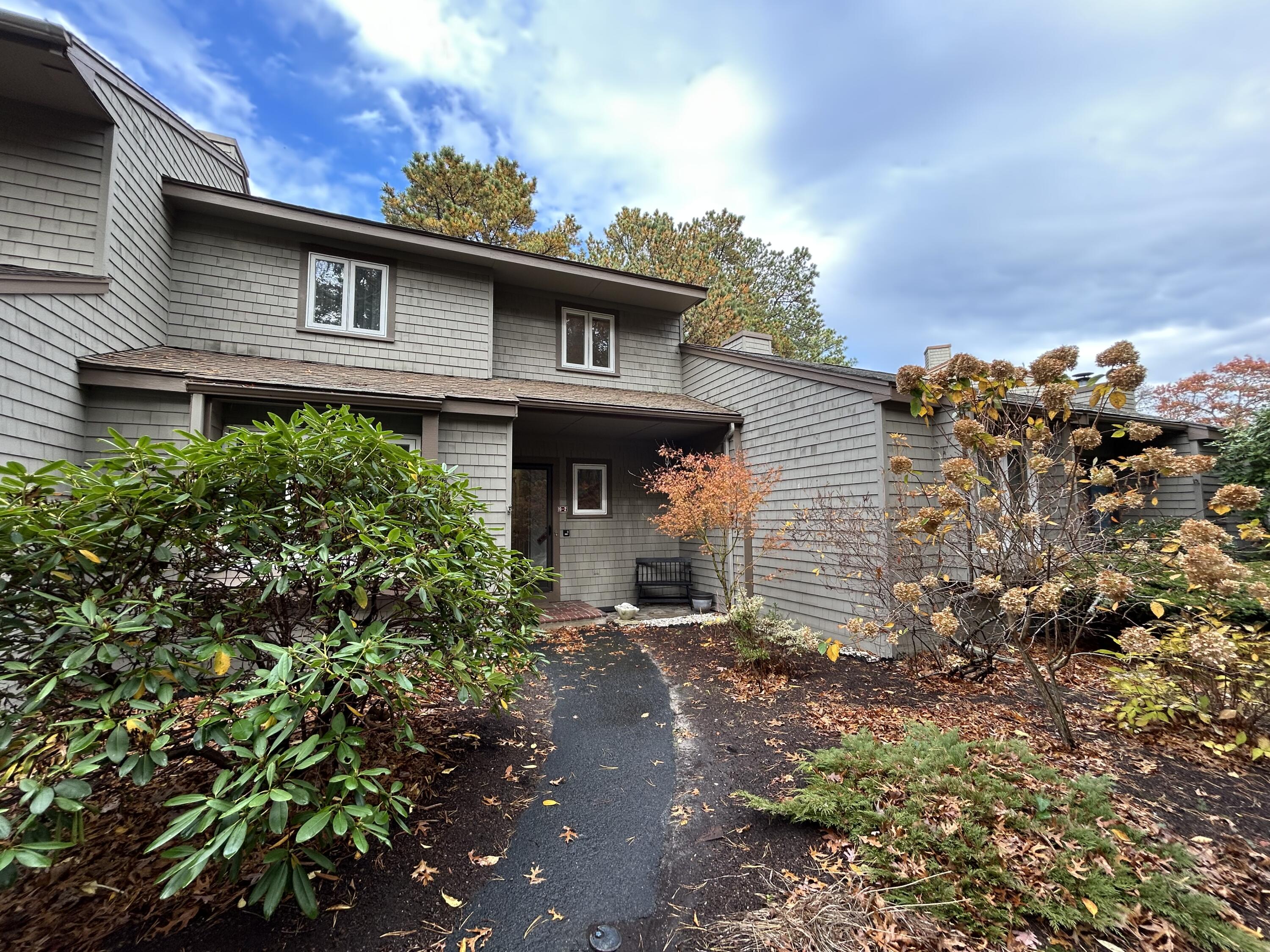 59 Main Street, Unit 192 Dennis, MA 02638 - Photo 2 of 44 front view of a house with a yard