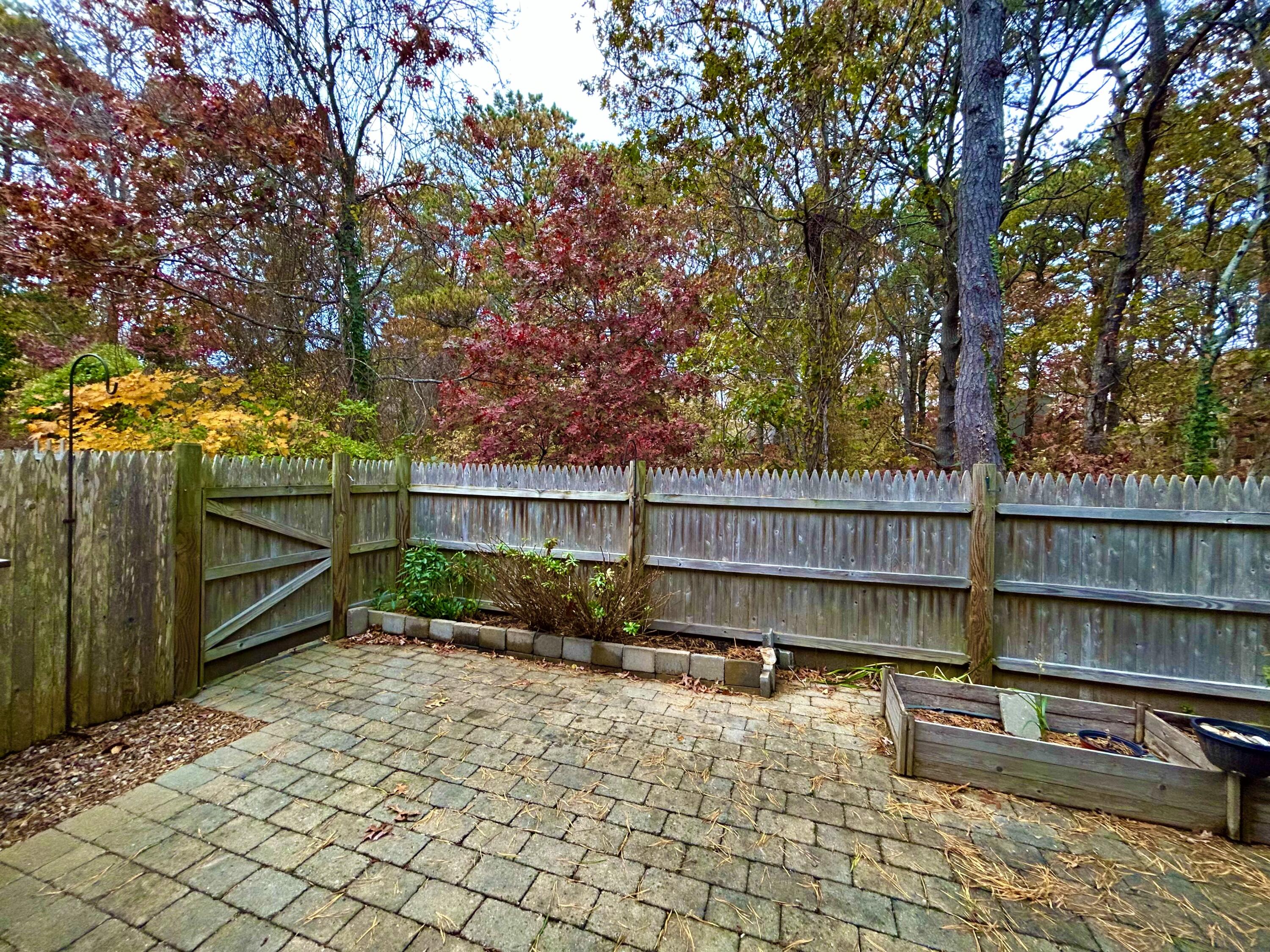 59 Main Street, Unit 192 Dennis, MA 02638 - Photo 34 of 44 a backyard of a house with lots of green space