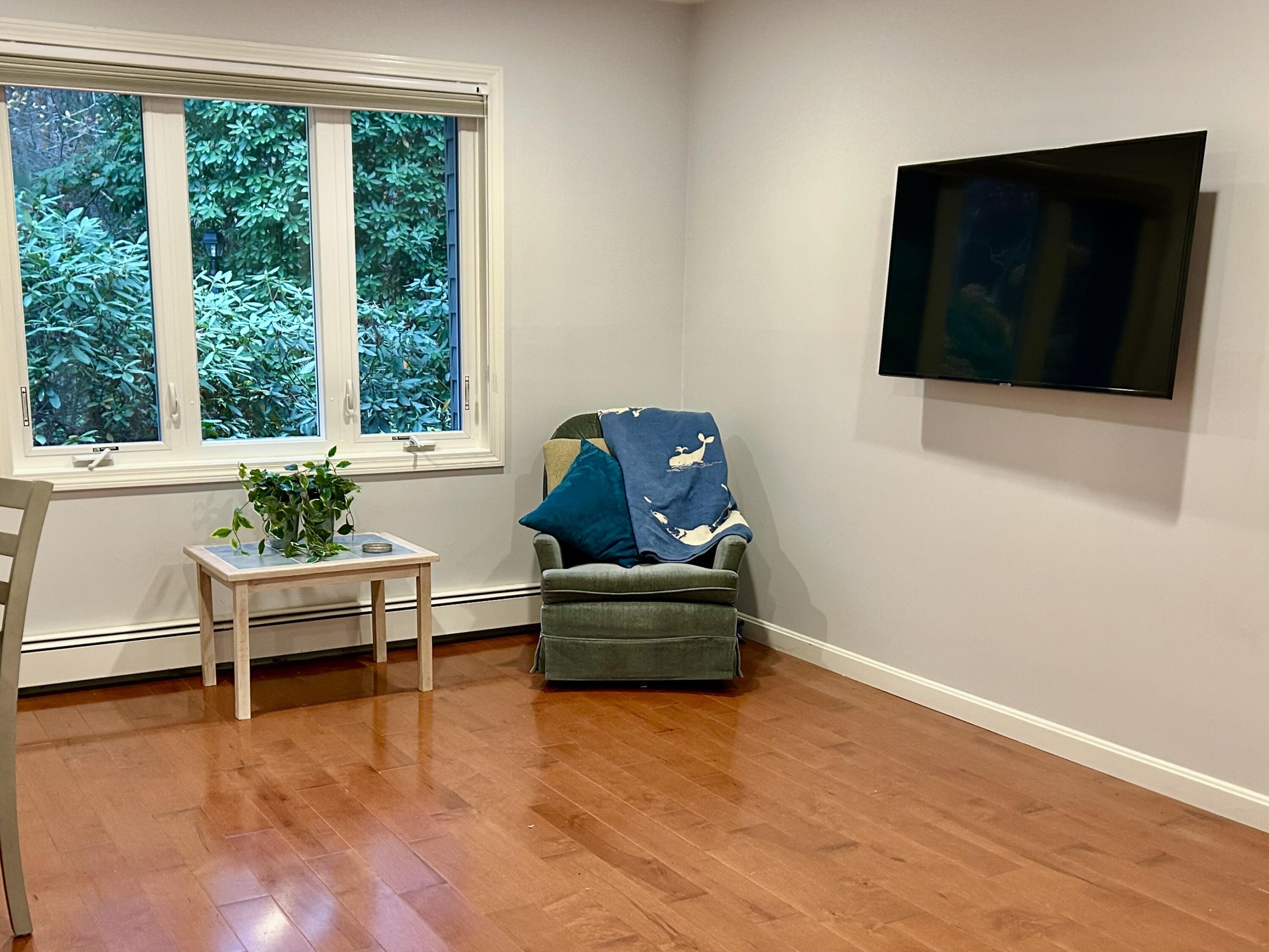 59 Main Street, Unit 192 Dennis, MA 02638 - Photo 7 of 44 a living room with furniture and a flat screen tv