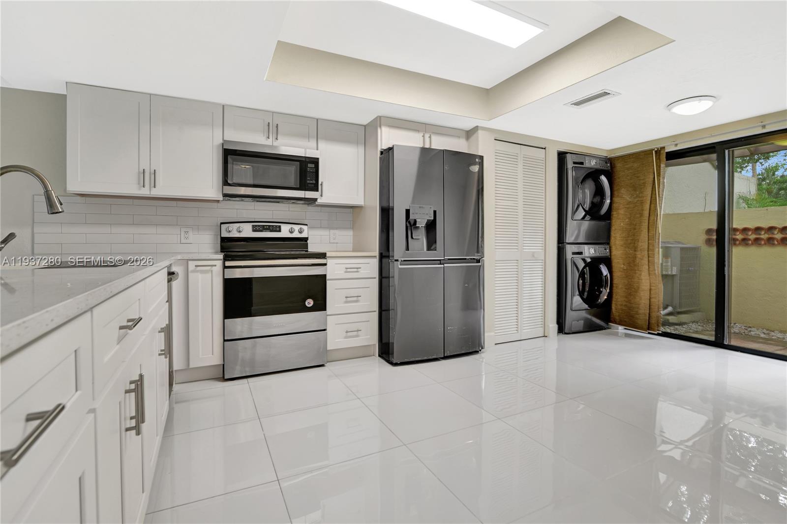 3114 Kingswood Terrace Boca Raton, FL 33431 - Photo 15 of 40 a kitchen with stainless steel appliances granite countertop a refrigerator and a sink