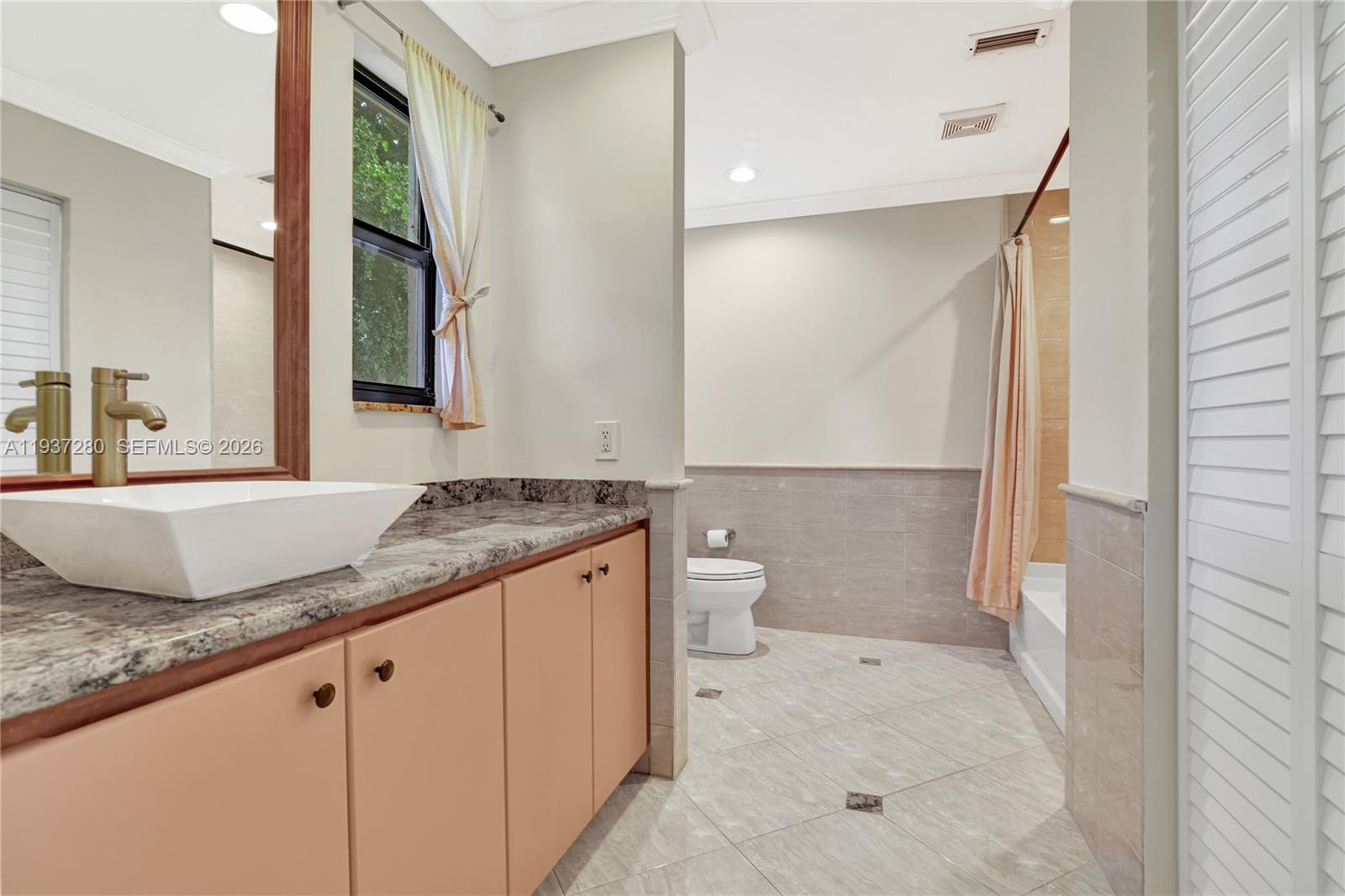 3114 Kingswood Terrace Boca Raton, FL 33431 - Photo 23 of 40 a bathroom with a granite countertop sink and a mirror