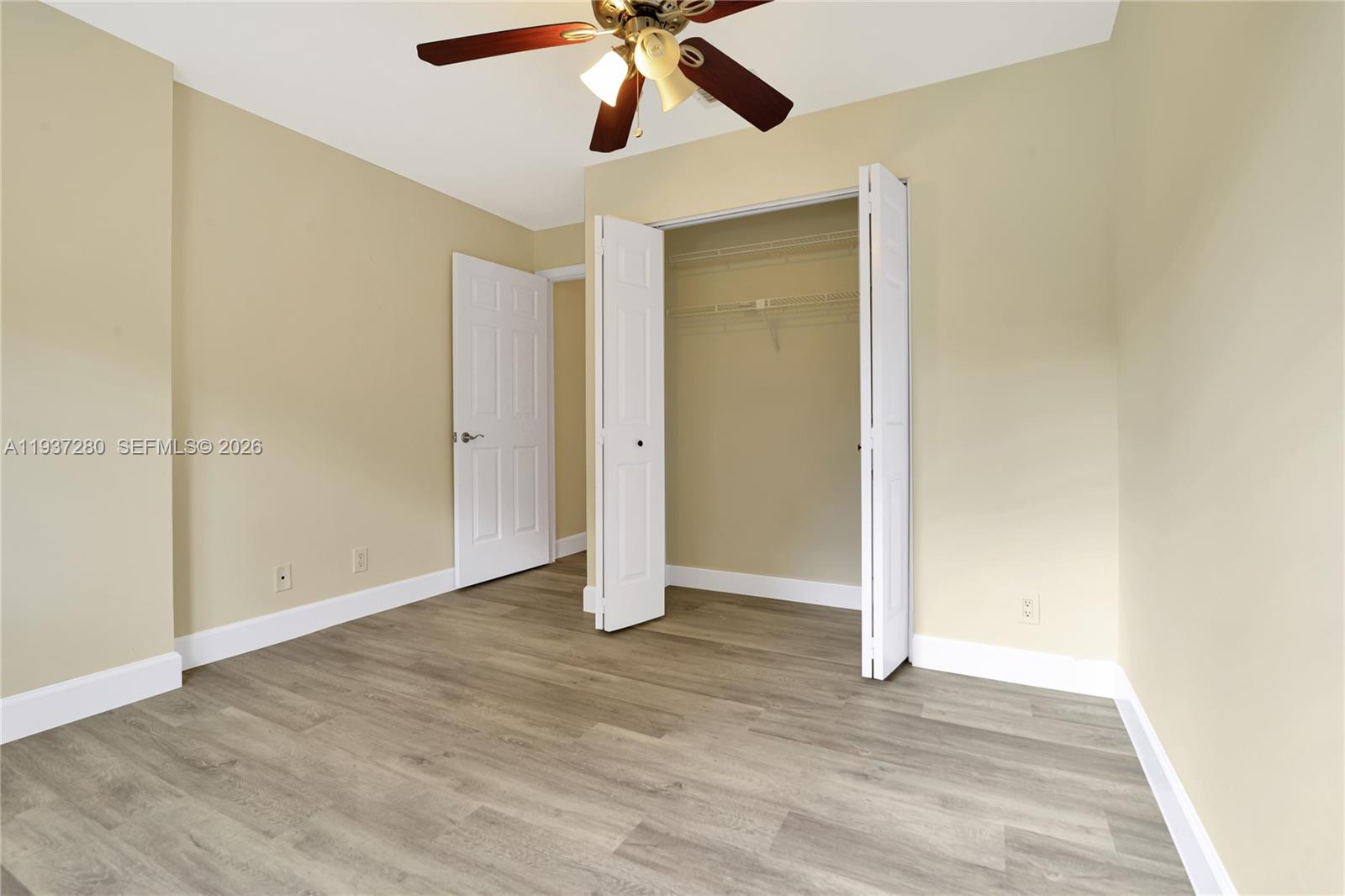 3114 Kingswood Terrace Boca Raton, FL 33431 - Photo 26 of 40 an empty room with wooden floor closet and ceiling fan