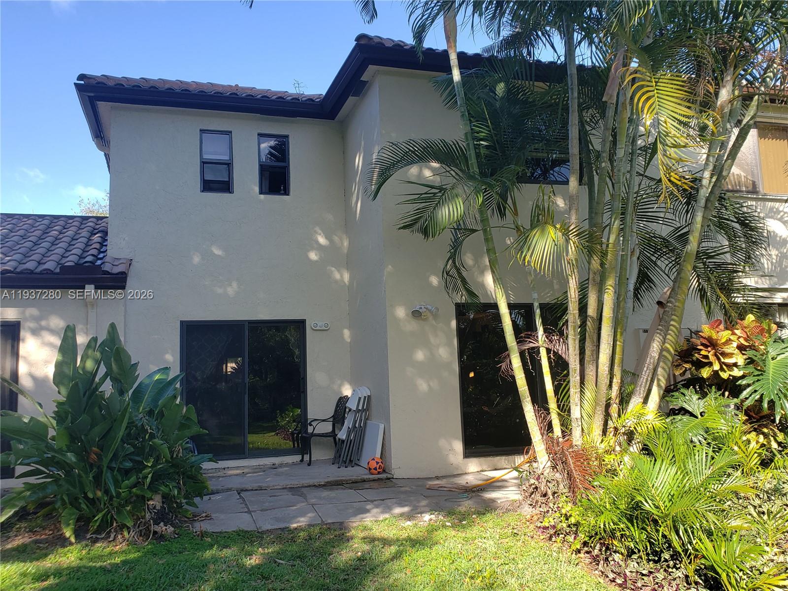3114 Kingswood Terrace Boca Raton, FL 33431 - Photo 28 of 40 a front view of a house with a yard