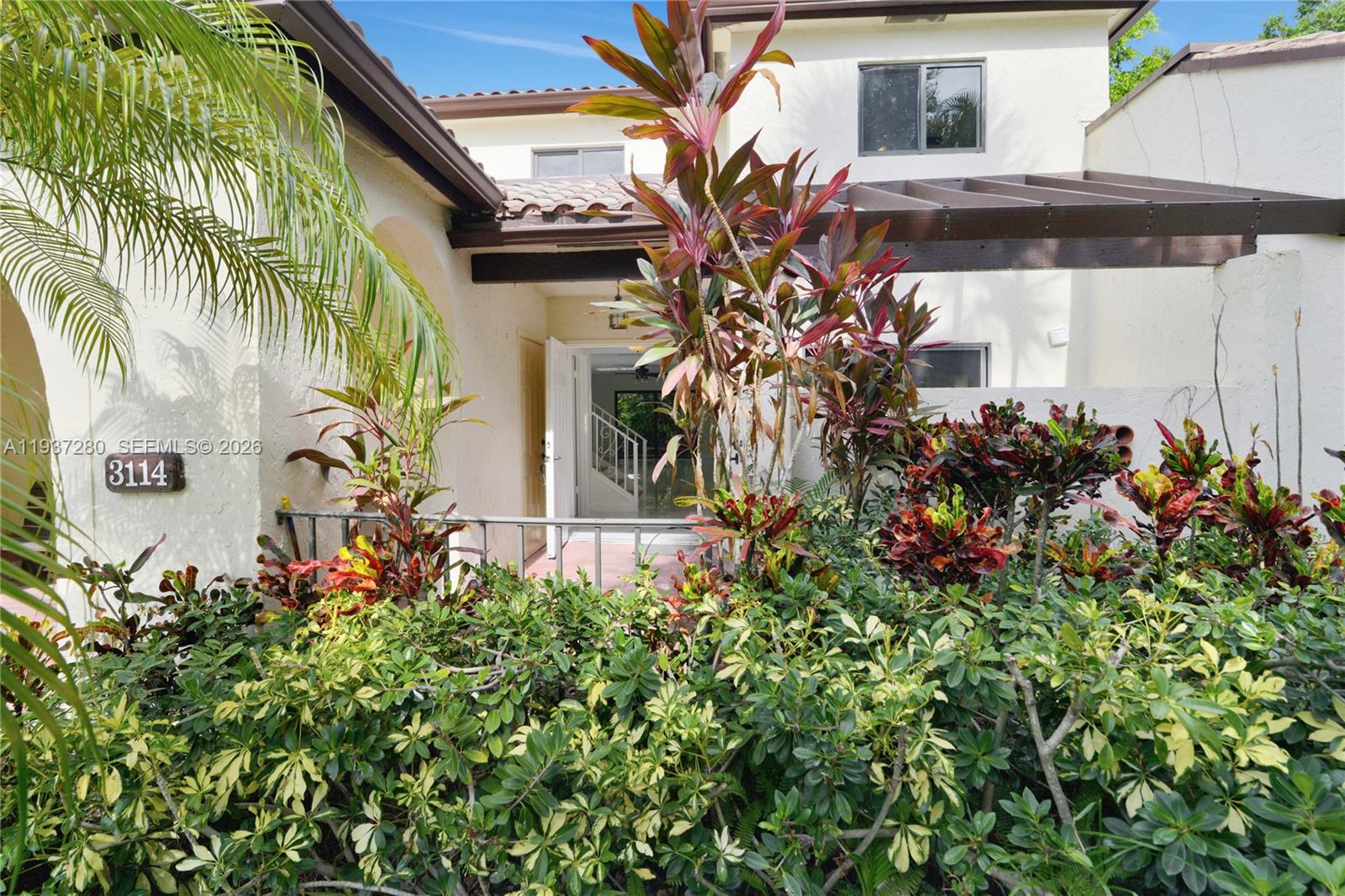 3114 Kingswood Terrace Boca Raton, FL 33431 - Photo 3 of 40 a view of a house with a flower garden
