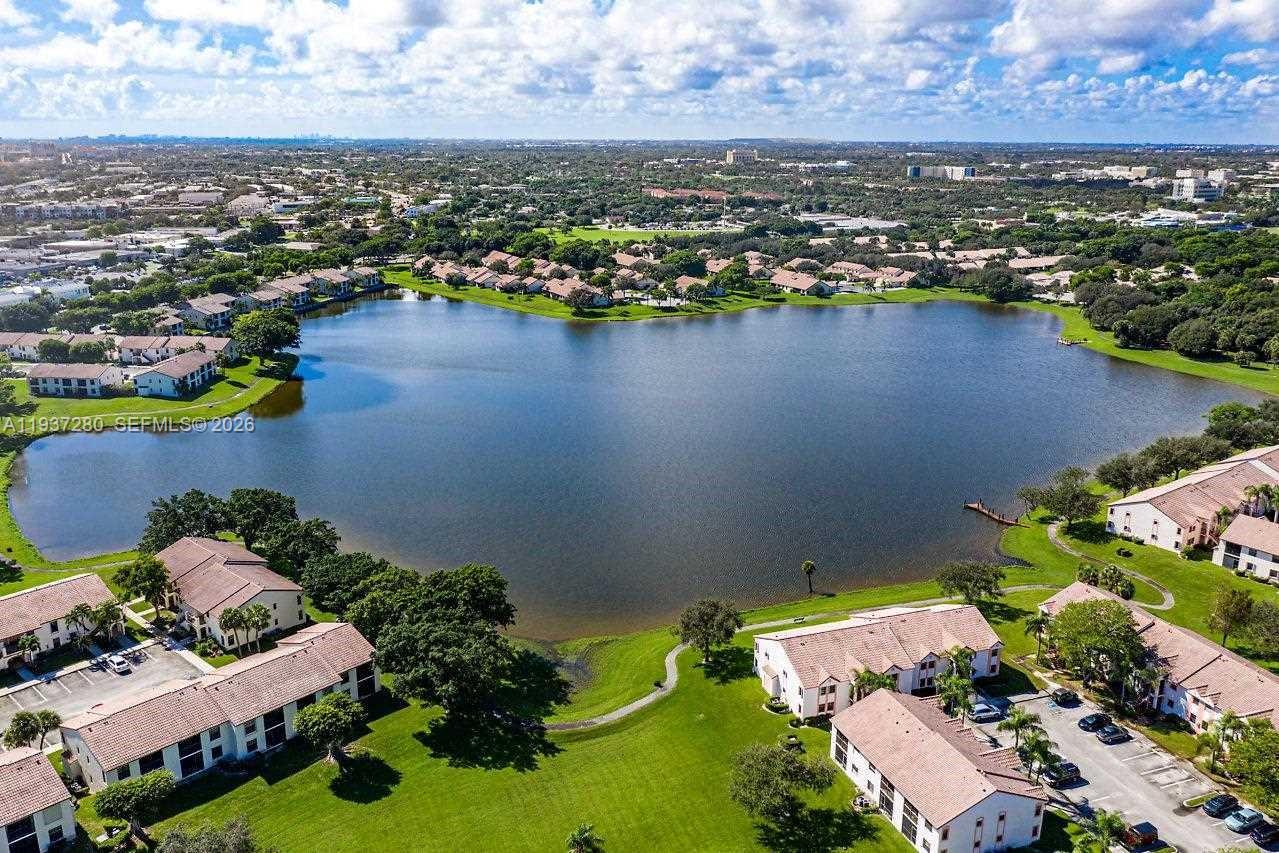 3114 Kingswood Terrace Boca Raton, FL 33431 - Photo 32 of 40 an aerial view of a house with a lake view