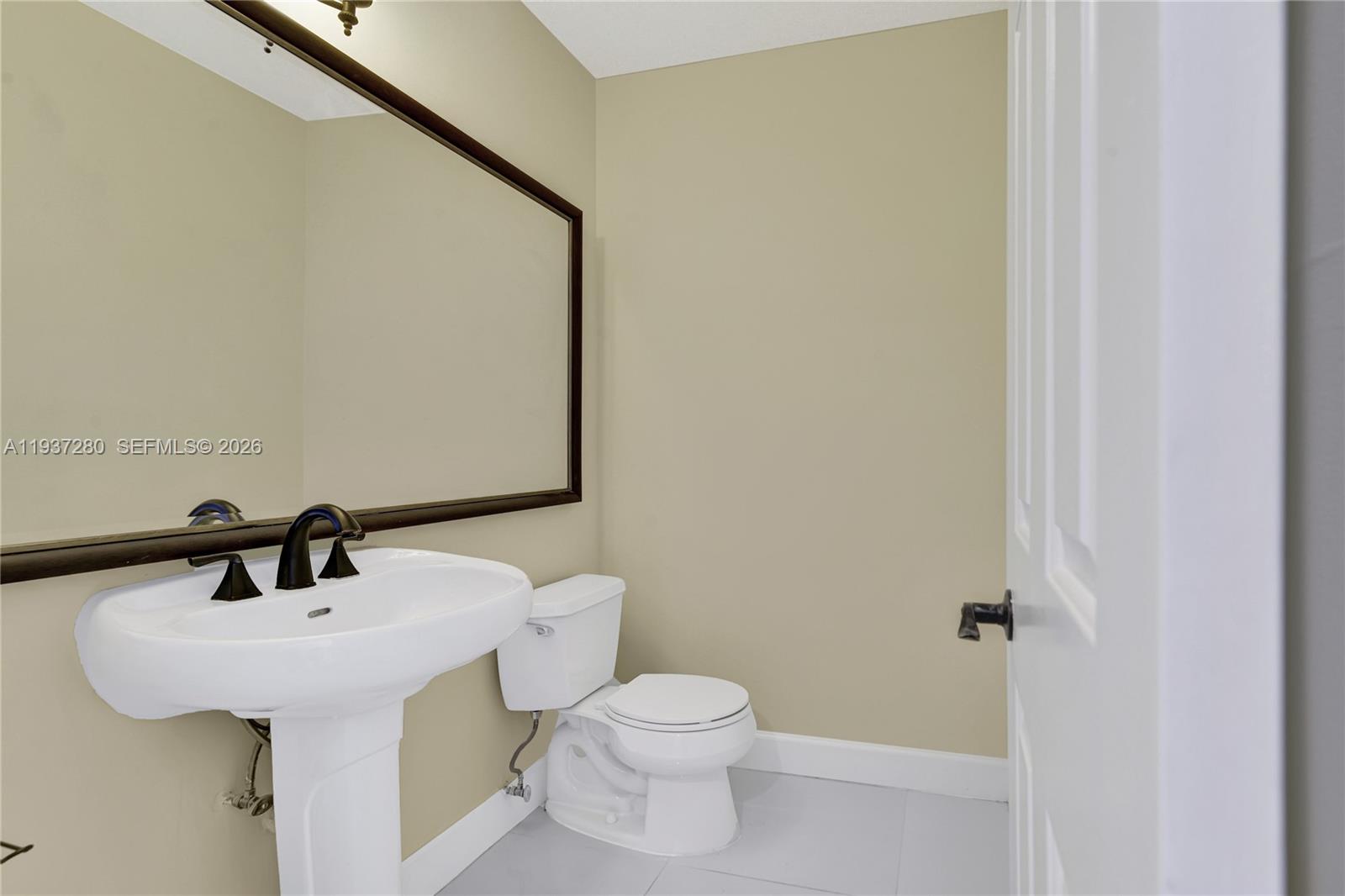 3114 Kingswood Terrace Boca Raton, FL 33431 - Photo 9 of 40 a bathroom with a sink a toilet and mirror