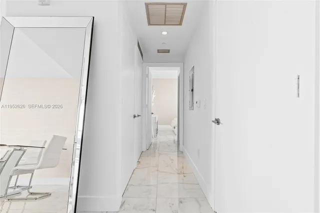 a kitchen with stainless steel appliances granite countertop a refrigerator sink and white cabinets