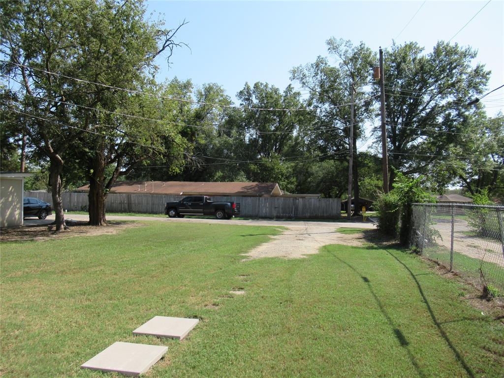 1402 Walnut Street Commerce, TX 75428 - Photo 8 of 11 a view of a backyard