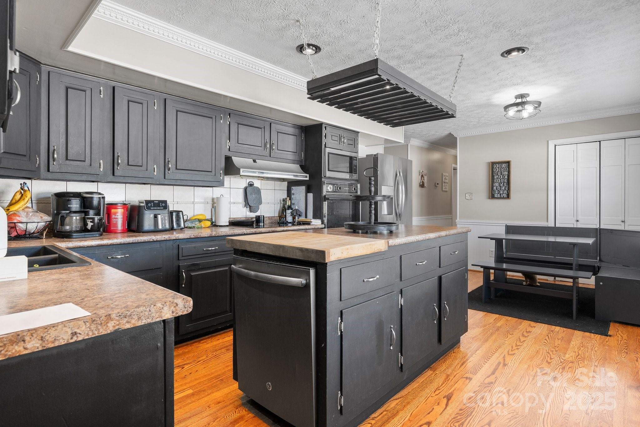 2596 Sweetbriar Circle Lenoir, NC 28645 - Photo 11 of 47 a kitchen with stainless steel appliances granite countertop a stove a sink and a refrigerator