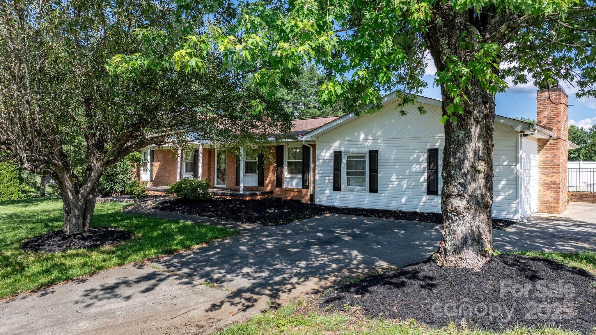 2596 Sweetbriar Circle Lenoir, NC 28645 - Photo 2 of 47 a front view of a house with garden