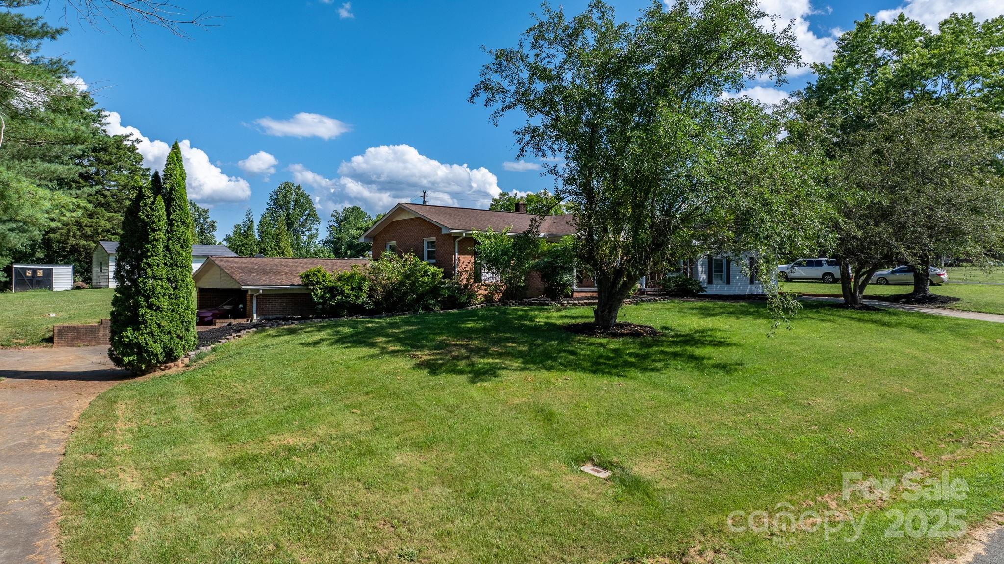 2596 Sweetbriar Circle Lenoir, NC 28645 - Photo 24 of 47 a view of a garden with a fountain