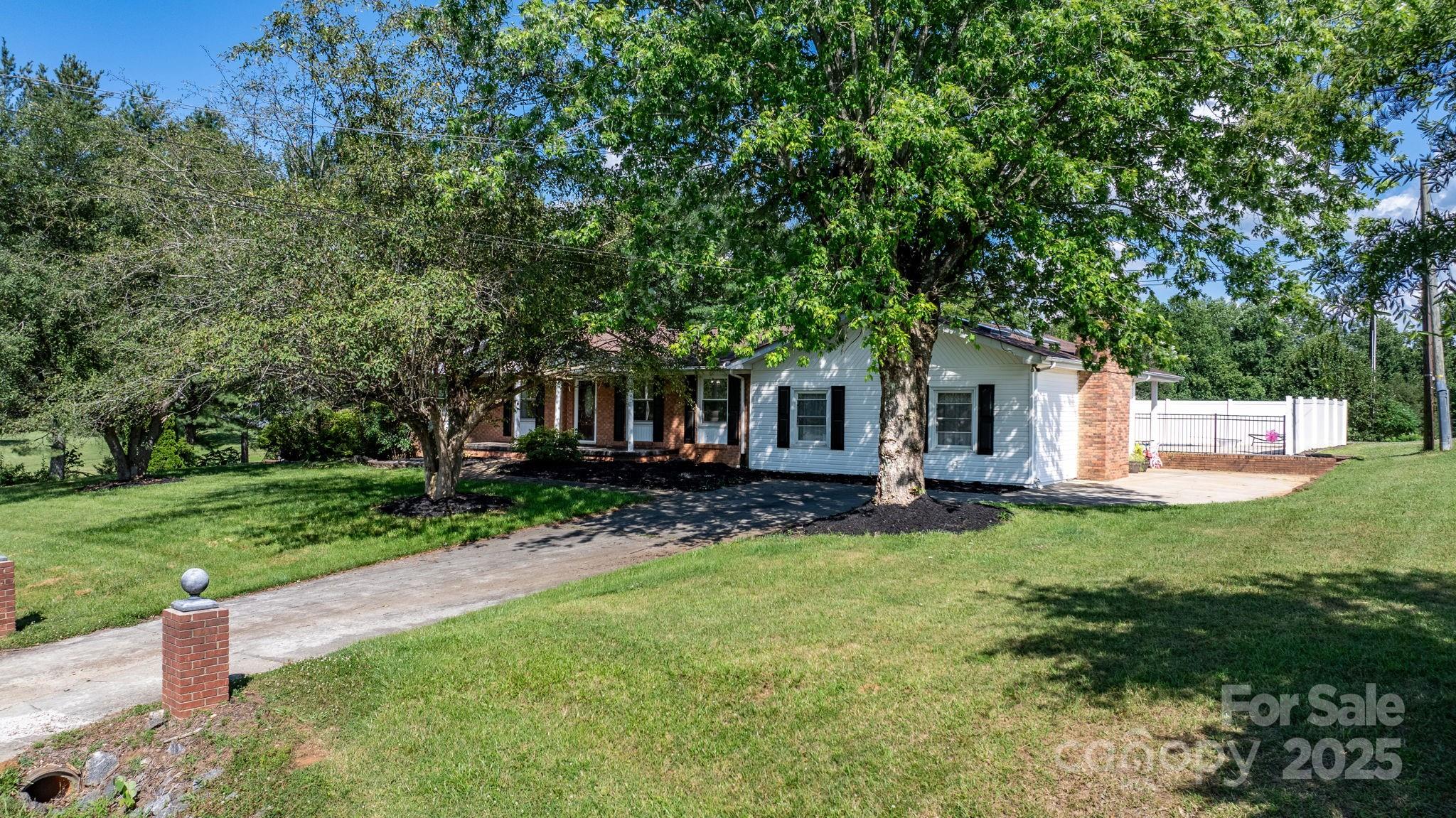 2596 Sweetbriar Circle Lenoir, NC 28645 - Photo 26 of 47 a view of a house with a yard and sitting area