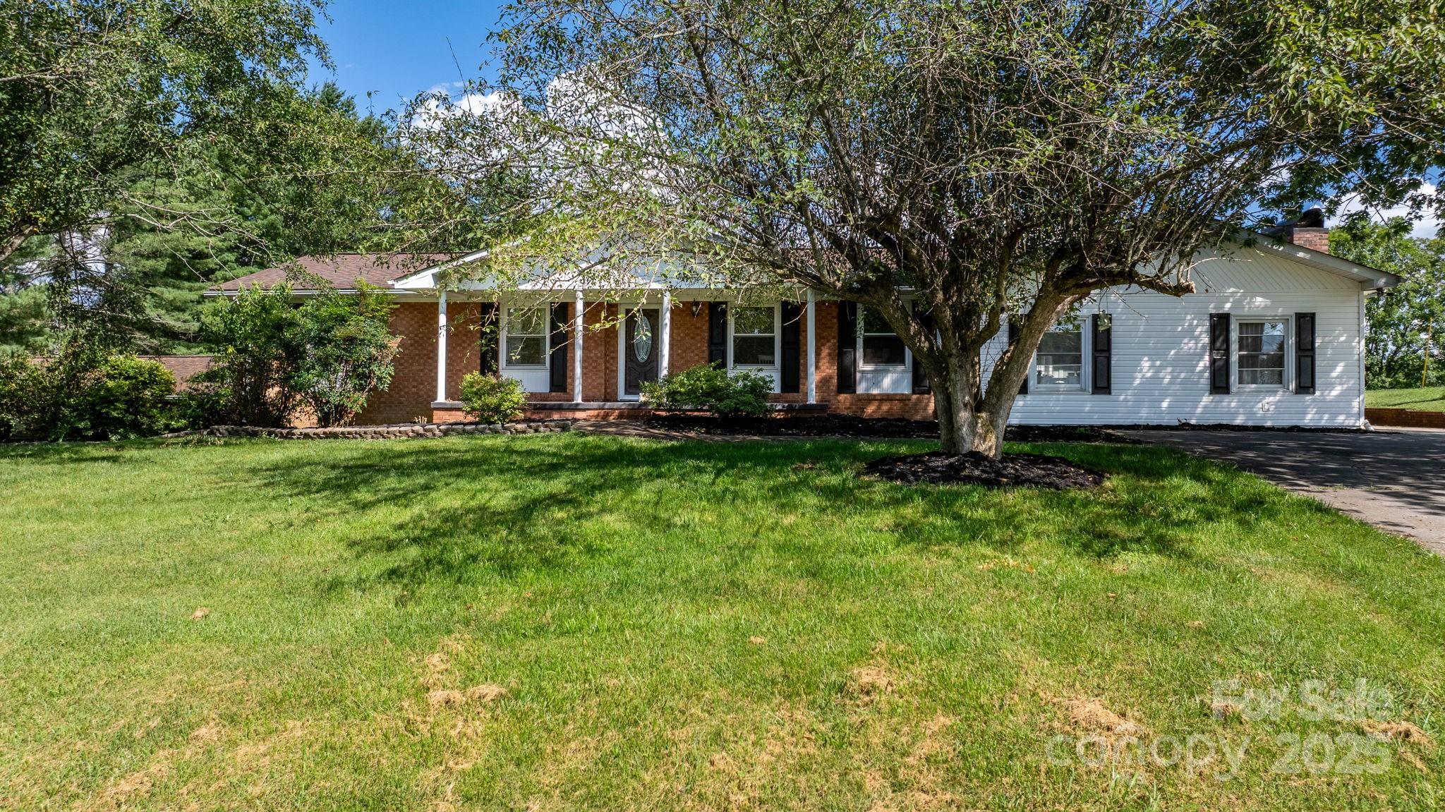 2596 Sweetbriar Circle Lenoir, NC 28645 - Photo 27 of 47 a front view of house with yard and green space