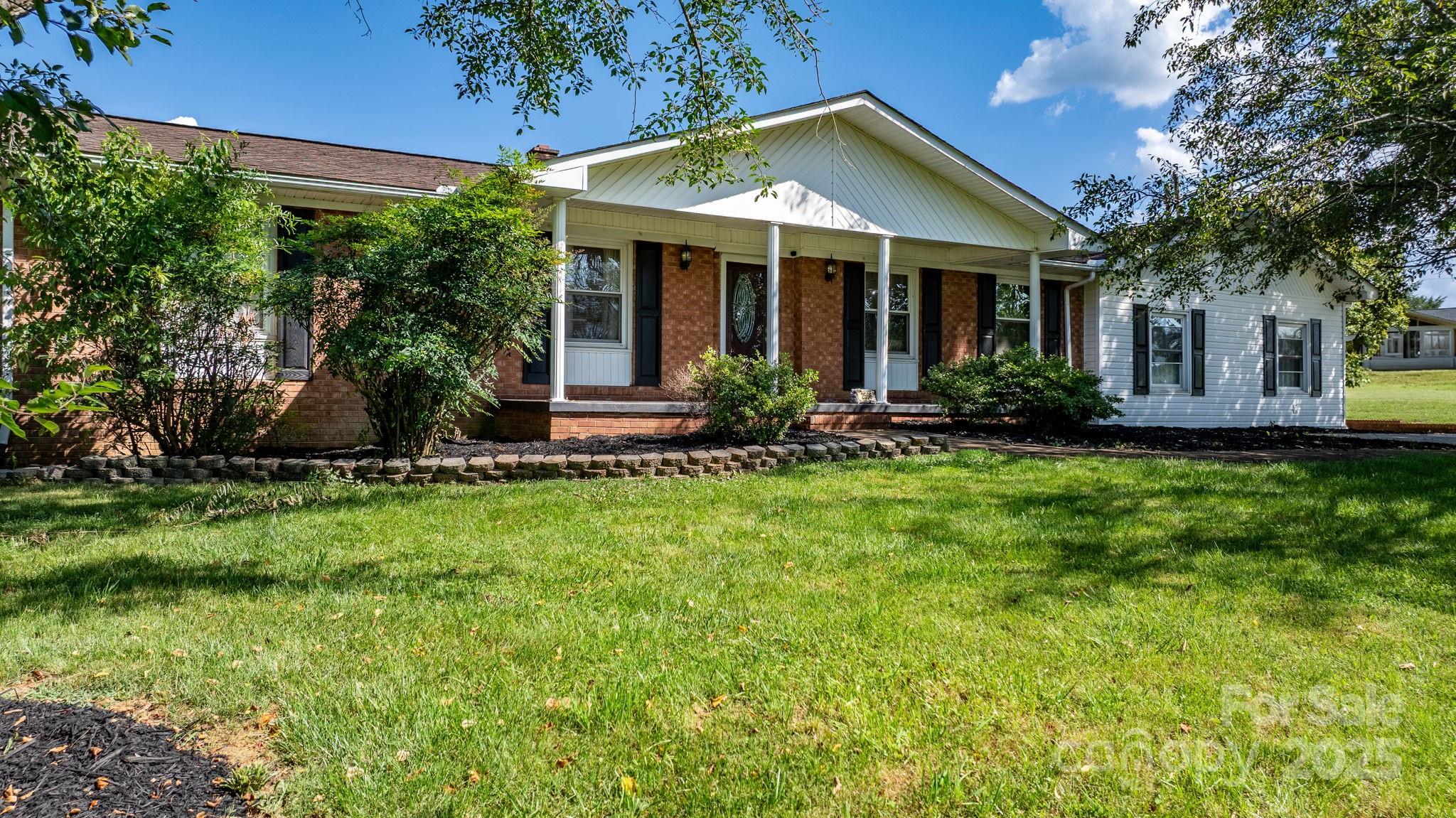 2596 Sweetbriar Circle Lenoir, NC 28645 - Photo 28 of 47 a front view of a house with a yard and outdoor seating