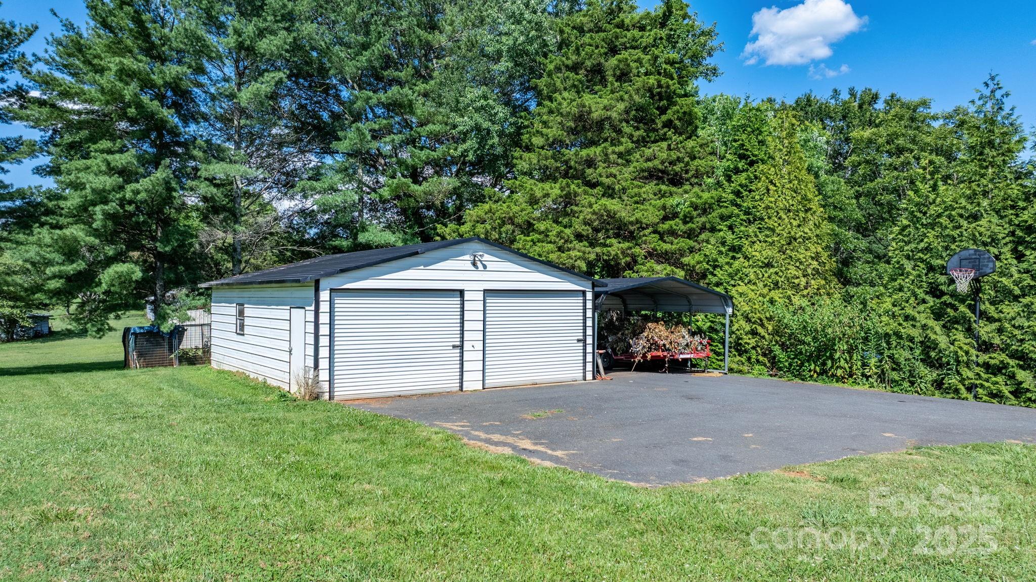 2596 Sweetbriar Circle Lenoir, NC 28645 - Photo 41 of 47 a view of a house with a yard and large trees