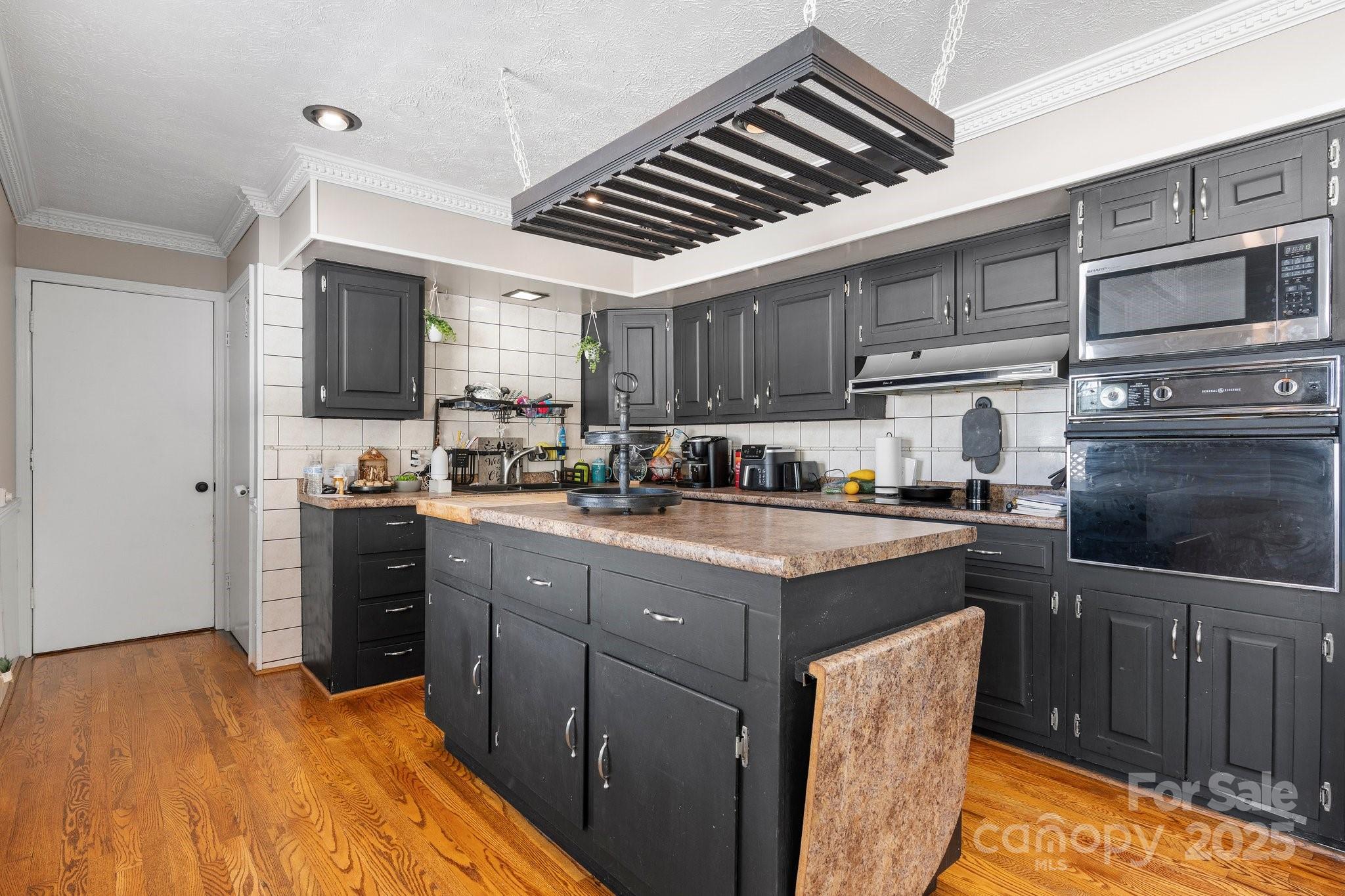 2596 Sweetbriar Circle Lenoir, NC 28645 - Photo 9 of 47 a kitchen with stainless steel appliances granite countertop a sink stove and refrigerator