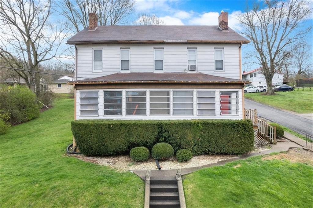 125 Center Avenue Burgettstown, PA 15021 - Photo 1 of 32 a front view of a house with a garden