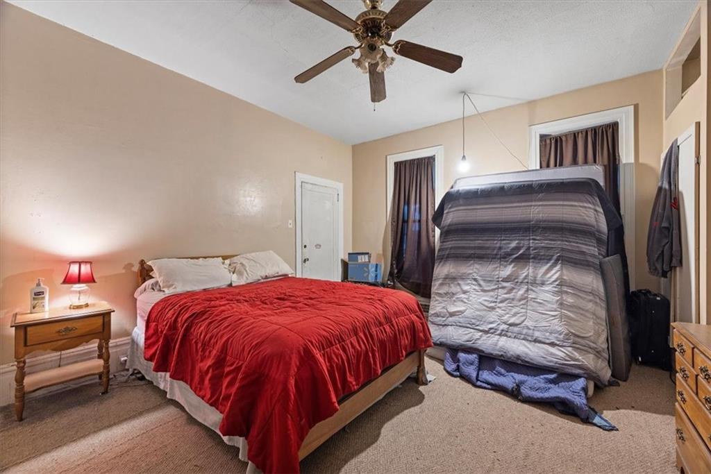 125 Center Avenue Burgettstown, PA 15021 - Photo 11 of 32 a spacious bedroom with a bed and a chandelier