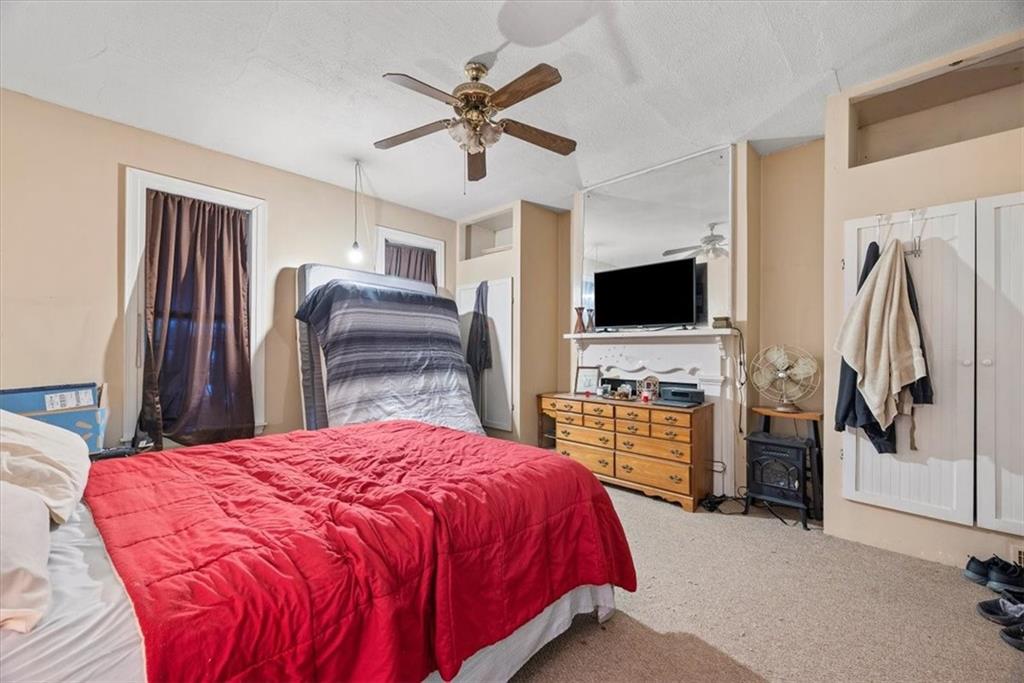 125 Center Avenue Burgettstown, PA 15021 - Photo 12 of 32 a spacious bedroom with a bed and a flat screen tv
